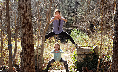 Jedi training at forest-based homeschool program children holding poses on rock formations