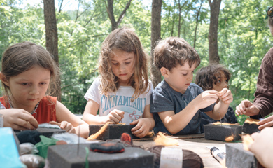 Children deep in the forest at Asheville homeschool crafting class