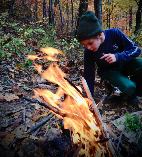 Homeschool student at fall nature program successfully starting a camp fire