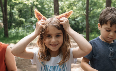 Gril with felted fox ears that she crafted at camp