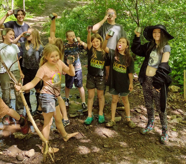 Kids goofing around in the forest some in costume at a Forest Floor program