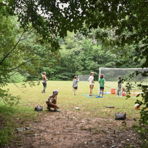 The soccer field surrounded by forest at Asheville summer camp
