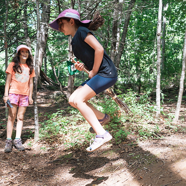 Bramblehurst camper flying thru the air in the forest on a newly minted broom