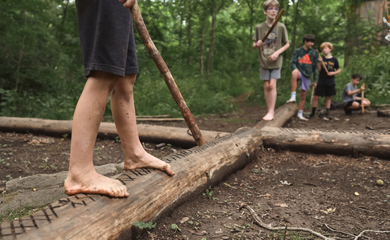 Preteen homeschool kids playing fun Forest Jedi game at Asheville forest school