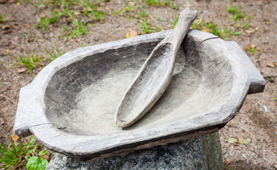 Carved wooden bowl and spoon made by hand with primitive tools