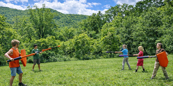 Two teams face off on the playing field at advanced boffing summer camp